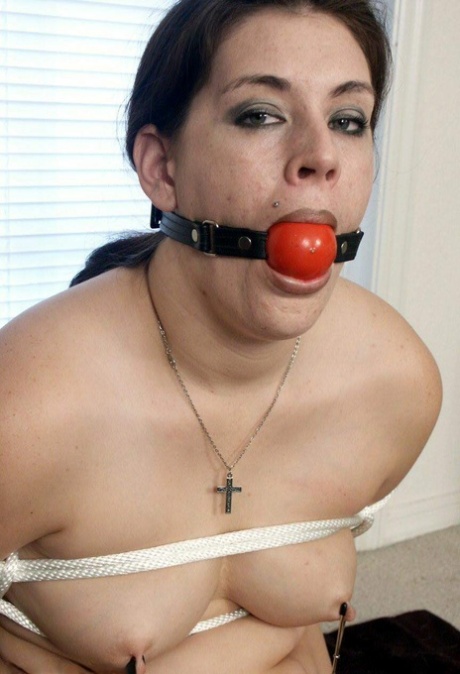 Girly: The chubby woman performs the ball gag and uses nipple clamps while restrained in her panties.