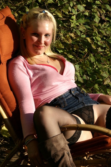 Suede boots are worn by the blonde amateur Mausibutz as she dilts her pussy on an outdoor chair.