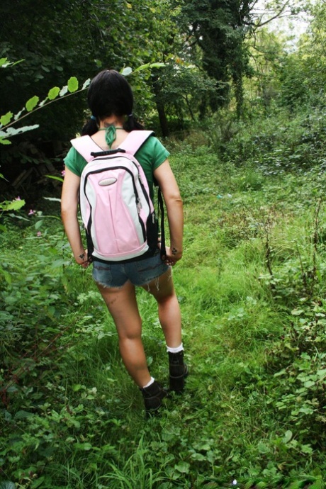 Elizabeth Lawrence, a woman with dark hair, engages in interracial sexual activity among greenery.