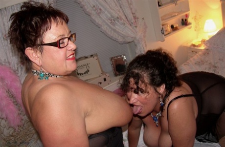 The fatter ladies engage in playing with each other's large breasts before putting on cum-covered facial hair.