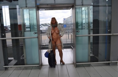 The airport observes a young blonde in a trench coat.