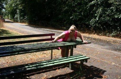 On a public picnic table, Lexie Cummings, an obese British amateur athlete, exposes herself.