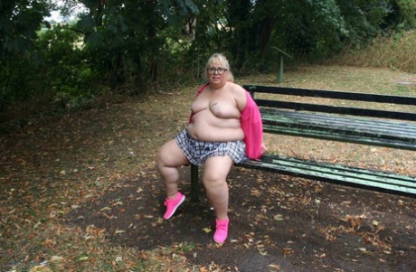 Lexie Cummings, an unclothed British amateur, exposes herself on a public picnic table.