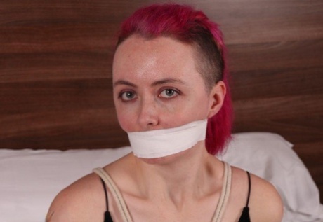 Fully clothed chick is tied up with ropes while silenced wit tape over mouth