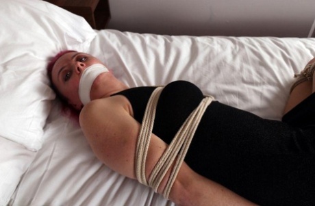 Fully clothed chick is tied up with ropes while silenced wit tape over mouth