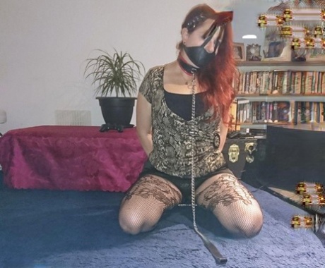The female with a redheaded appearance is depicted wearing a collar and leash in a few outfits while being gagged.