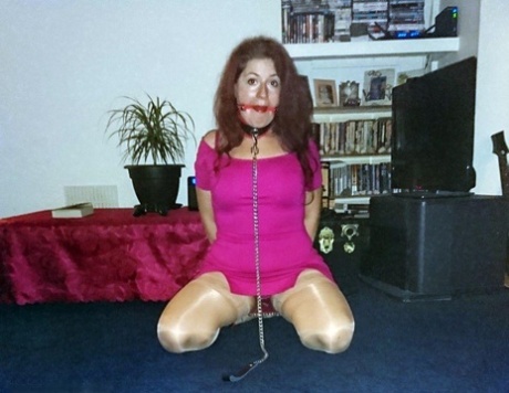 The female with a redheaded appearance is depicted wearing a collar and leash in a few outfits while being gagged.
