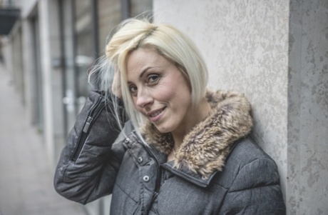 A blonde novice emerges from the darkness to do her makeup and perform oral sex.