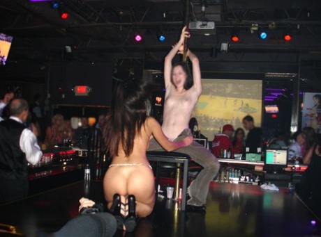 The candid photos show Asian stripper Katsuni performing in an adult club.