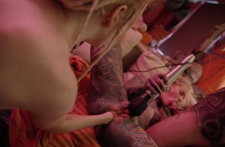 Heavily tattooed girls fist anal cavities during an interracial foursome