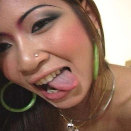 Noon, an attractive Asian female performs oral sex with her penis while swallowing semen.