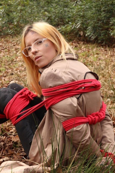 Natural redhead is left tied up and cleave gagged on dry leaves near the woods