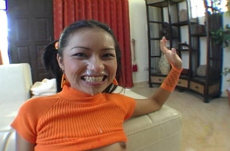 While engaging in POV sex, the young Asian girl Jantra has semen on her face.
