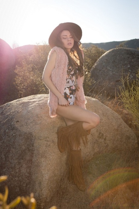Centerfold model Drew Catherine strips to her boots for Playboy amid boulders