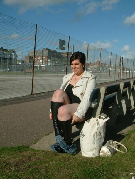 Brunette fatty takes the stage and exposes herself on a public bench before masturbating.