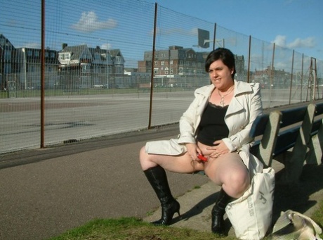 The brunette fatty exposes herself on a public bench before engaging in self-pleasure.