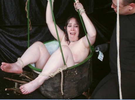 A female sex slave who is overweight locks herself in a basket during needle play.
