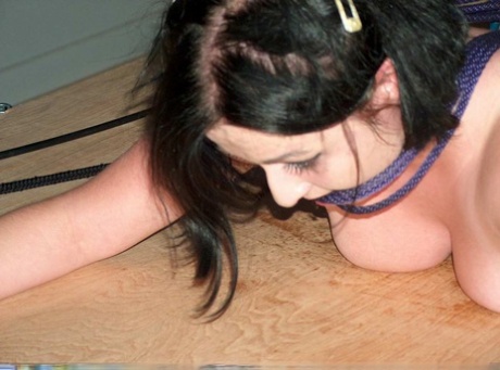 Hot wax dries the backside of the dark-haired girl during her bondage.