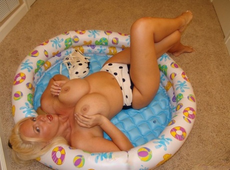 Blonde MILF Karen Fisher frees her fake tits from a bikini in a child's pool