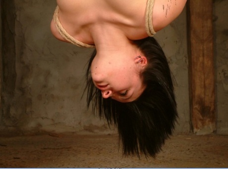 Involved: A naked woman has wax poured over her breasts while hanging upside down.