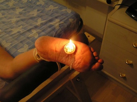 Glued up to the soles of white girl feet with lit candles.