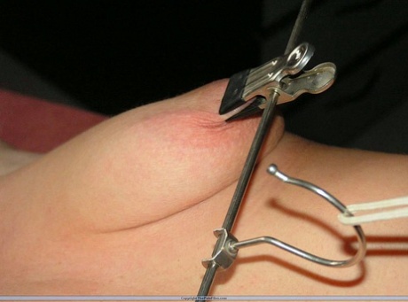 Blindfolded and restrained, the female nipple torturer is a female pain slut.