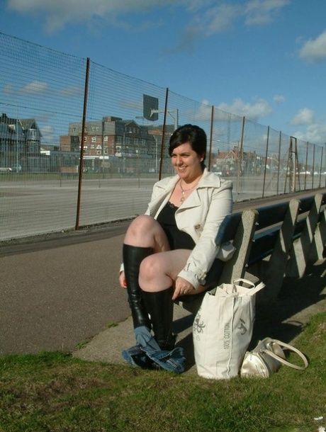 An overweight woman in the UK masturbates on a public bench.