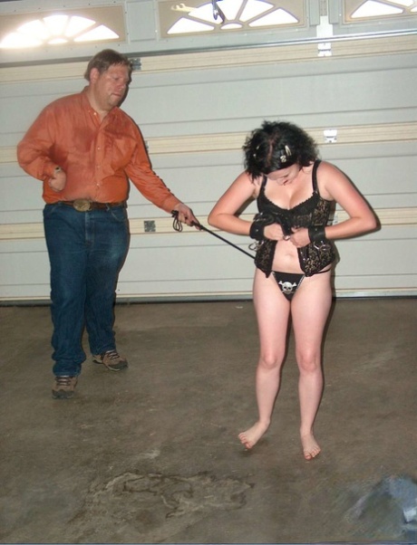 Chilly brunette in a garage is subjected to painful BDSM play.