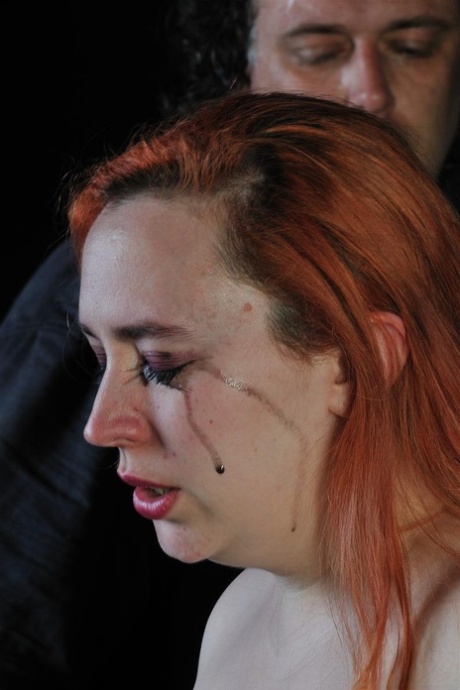 Tormenting a fat redhead is done by a sadistic man who uses hot candle wax to torture him.