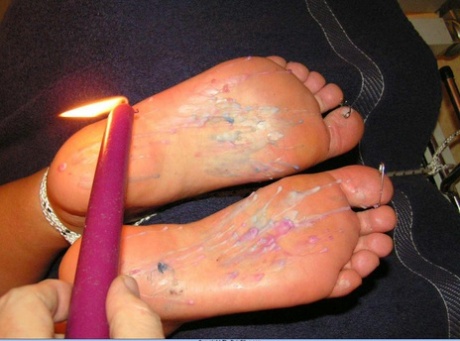 The Pain Files applied hot candle wax to the feet.