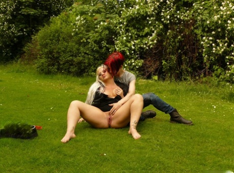 Before being joined by her lesbian partner, the slender blonde was seen masturbating on a grass field.