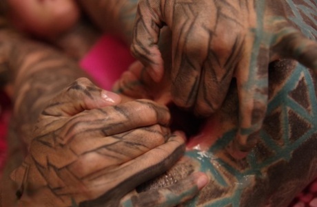 A heavily tattooed woman stretches her anus with her fingers while having a deep, painful rump.