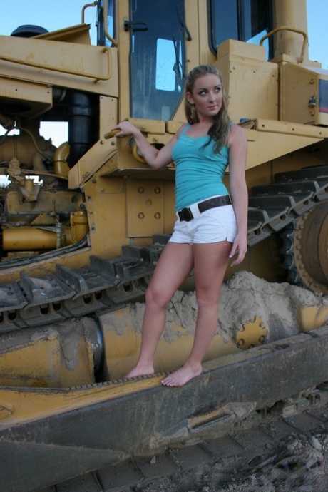 Teen first timer Abbie gets totally naked on tracks of heavy equipment