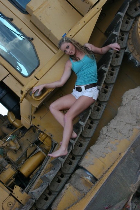 Teen first timer Abbie gets totally naked on tracks of heavy equipment