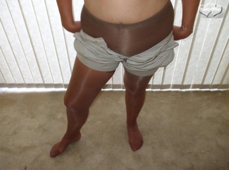 Middle-aged amateur Busty Bliss displays her tan lined tits in pantyhose