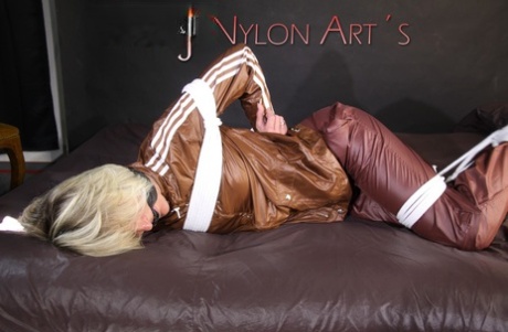 Watch as the attractive Sonja is tying and gagged on a bed with ropes and a clothgapper in the bedroom.