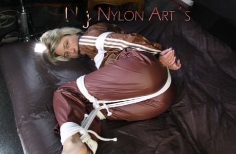 Viewing Sonja's arousing experiences of being tied up and gagged on a bed with ropes, as well as being clothgagging.