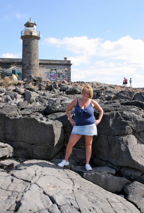 British beauty BBW Curvy Claire flaunts her large breasts while visiting the lighthouse at night.