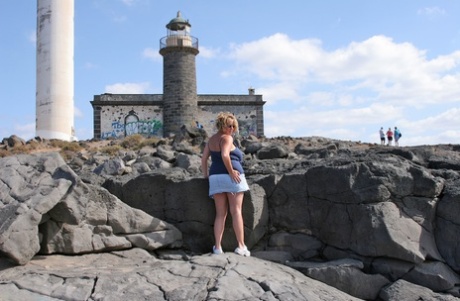 At a lighthouse, British beauty BBW Curvy Claire displays her large breasts.