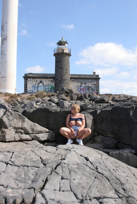BBW Curvy Claire, from Britain, displays her sizable breasts while visiting a lighthouse.