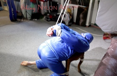 PIA tied, gagged and hooded on a stool and on the ceiling wearing a supersecy