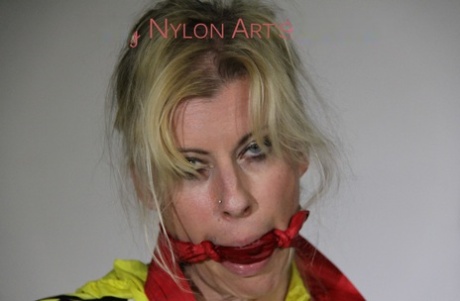 Sexy Lucy Tied An Gagged With Ropes And A Cloth Gag Wearing A Super Hot Red