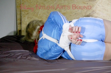 HOT HOT PIA being restrained and gagged on a sofa with ropes and cloth gags.