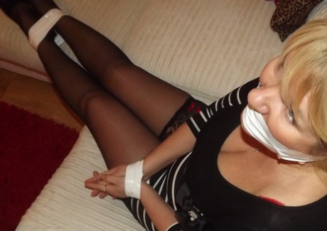 Attractive, the older blonde with fat flesh shows off her large tits while she is tied up and has short legs.