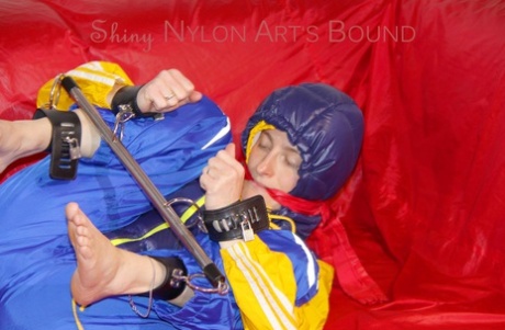 Sonja was hung with her hands tied and gagged on a bar, while she was also wearing a sexy raincoat and a hooded jacket on the sofa.