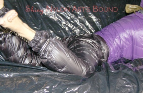 Sandra had her hands tied and gagged on a couch, while wearing cuffs and an ornate pillory in hot purple.