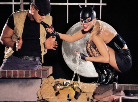 ATM: A hot blonde deep in the ass (left) while wearing a Catwoman mask.