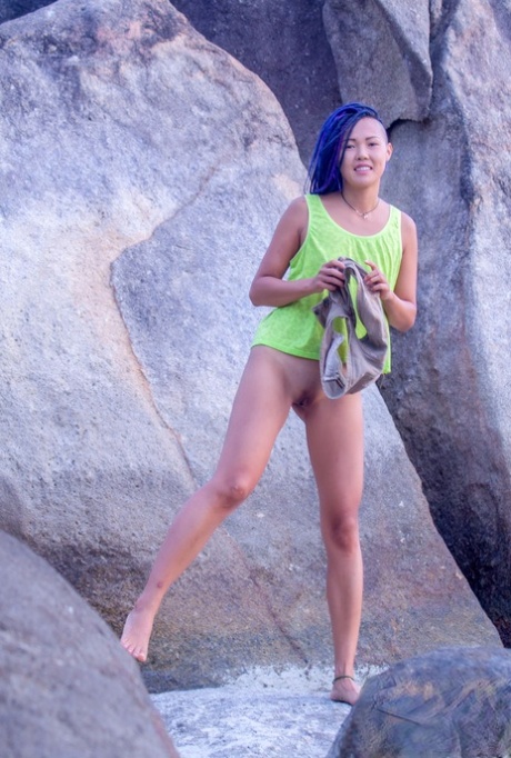 While in a sea cave, Sweet Julie, an Asian girl, goes completely naked.