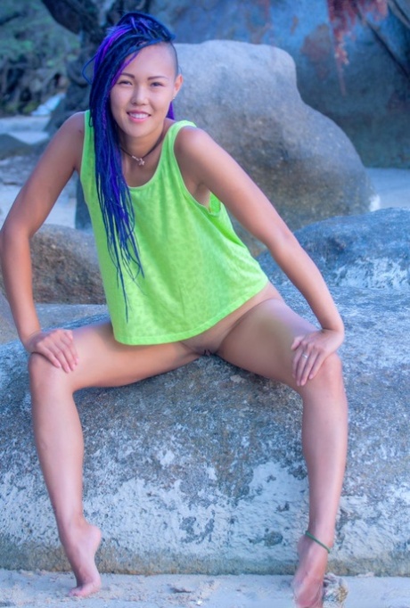 Asian teen Sweet Julie gets totally naked while inside a sea cave