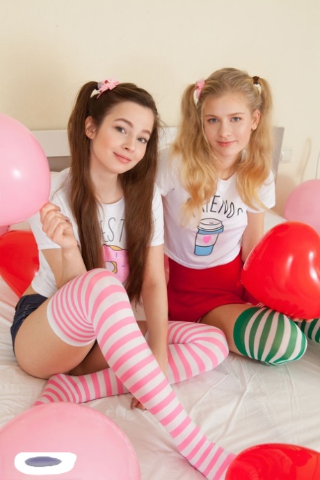 Young Looking Lesbians Amy & Angela Remove Their Striped Thigh Highs Together